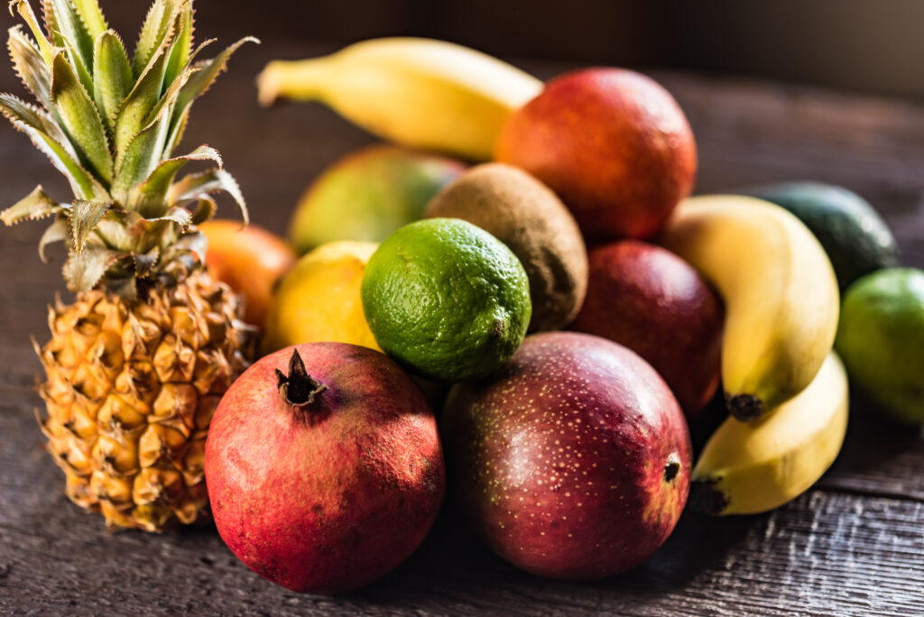 Close up delicious whole exotic fruits on wooden background. Selective focus